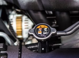 A close up of a car radiator cap.