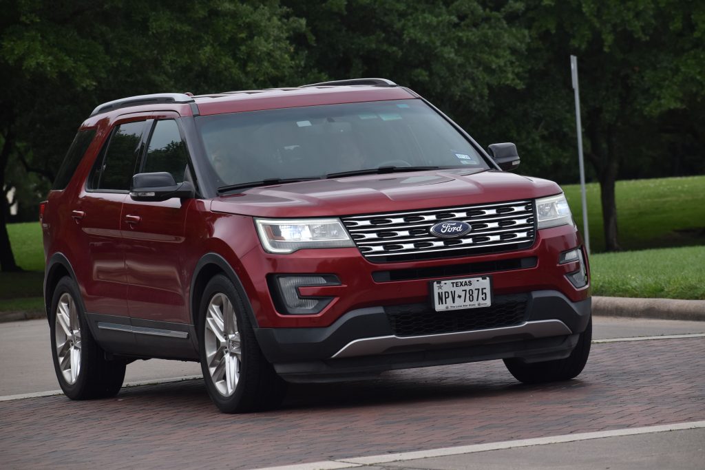 A red Ford Explorer parked.