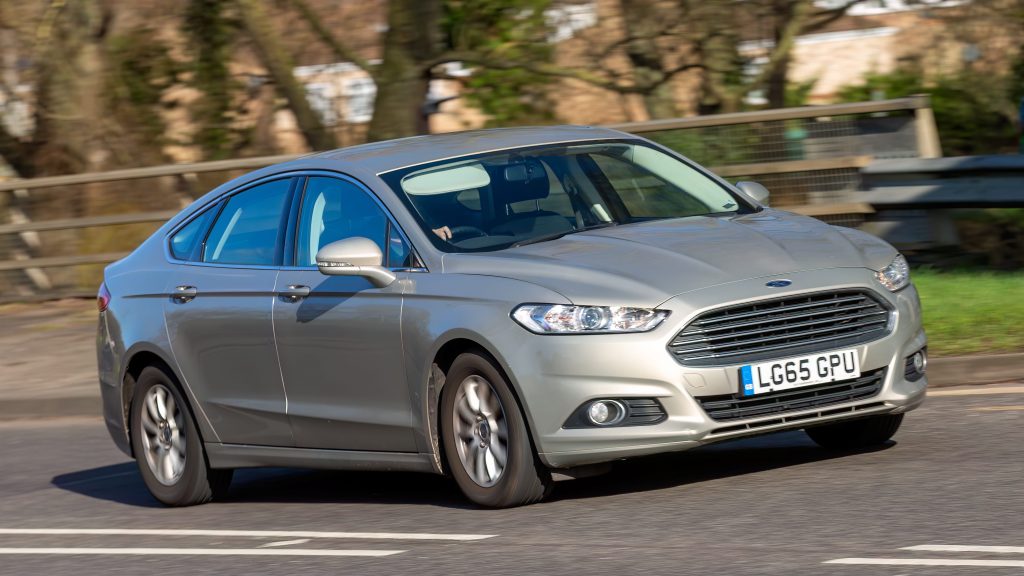 A silver Ford Mondeo driving on the road.