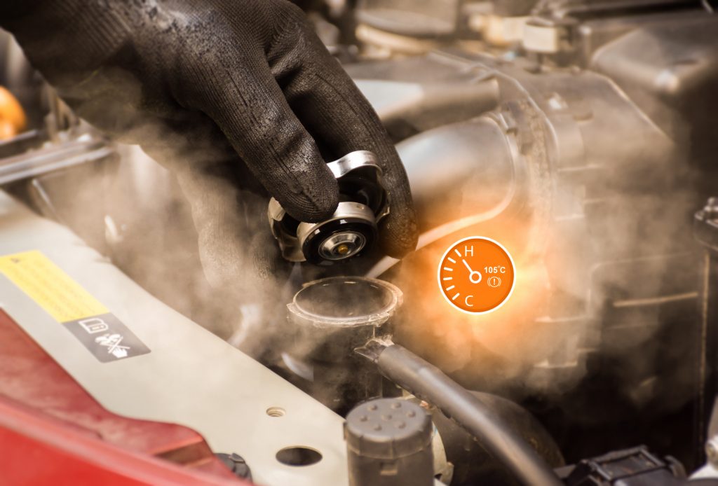 Mechanic removing a radiator cap from a hot engine with steam escaping from the cooling system.
